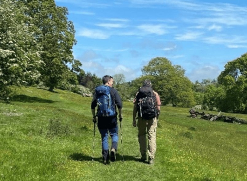 a photo from behind of Phil and Mark walking in the sunshine