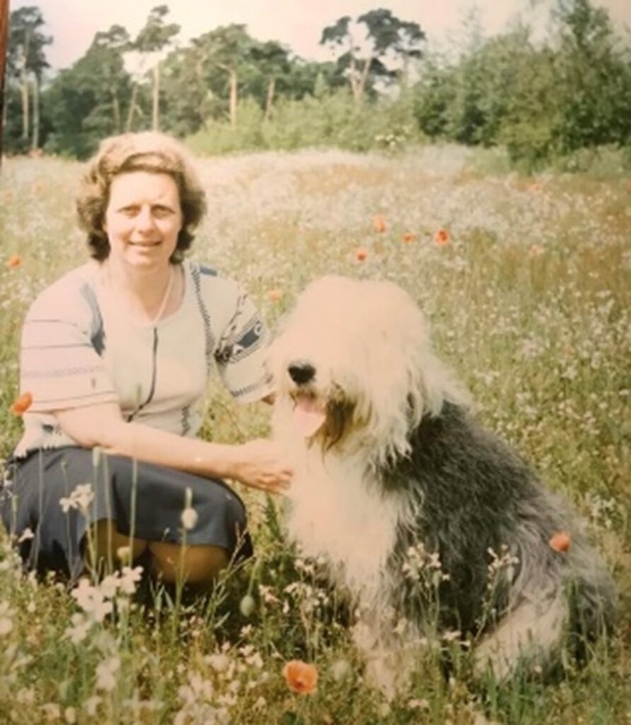 photo of Bobo with her dog in a meadow (and old english sheep dog)