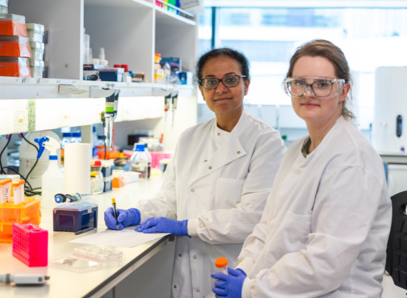 Two researchers smiling