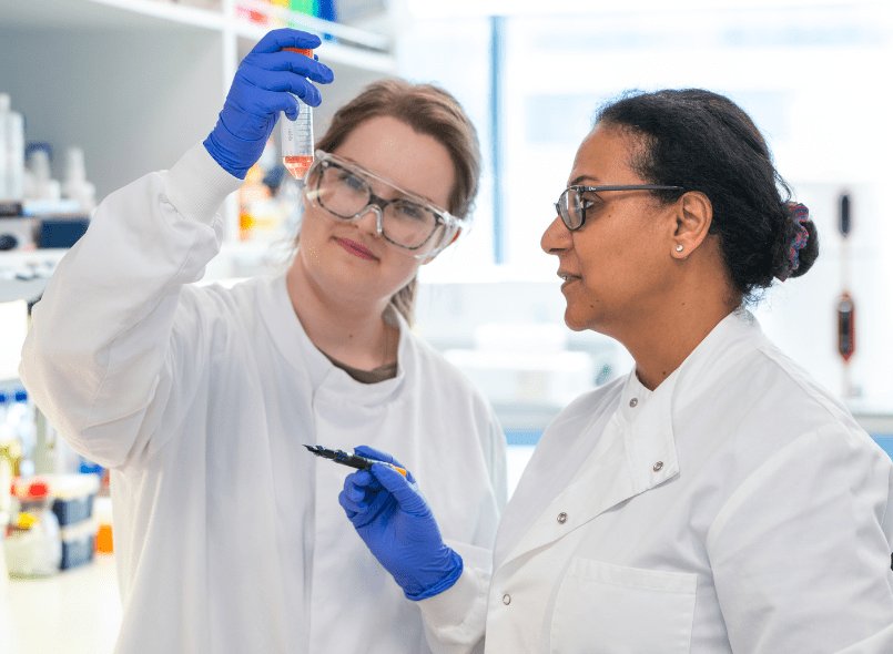 two researchers looking at a test tube