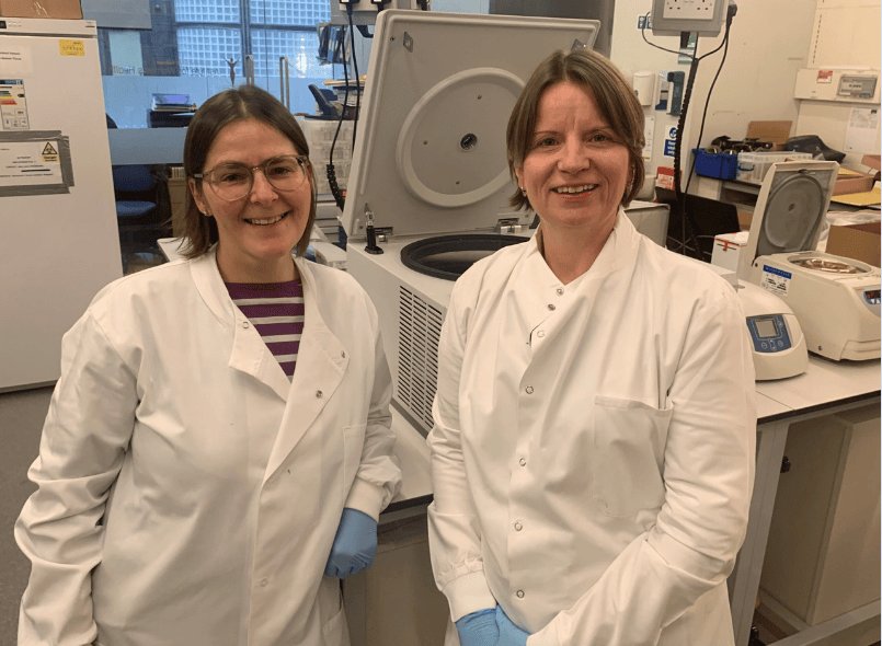 Two researchers smiling