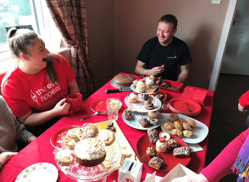 Two people at a tea party laughing