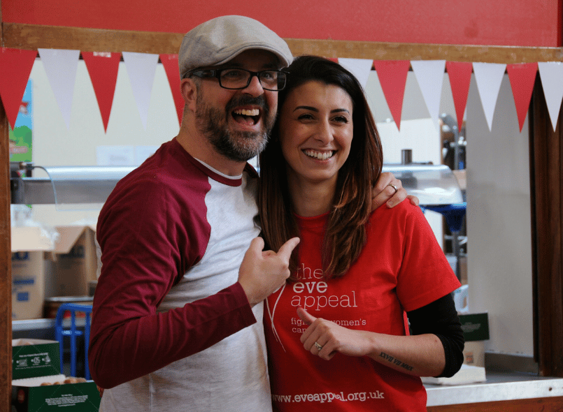 Two people smiling and pointing at each other