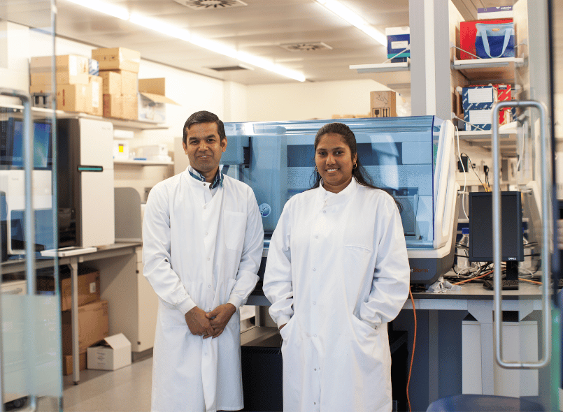 Two researchers smiling