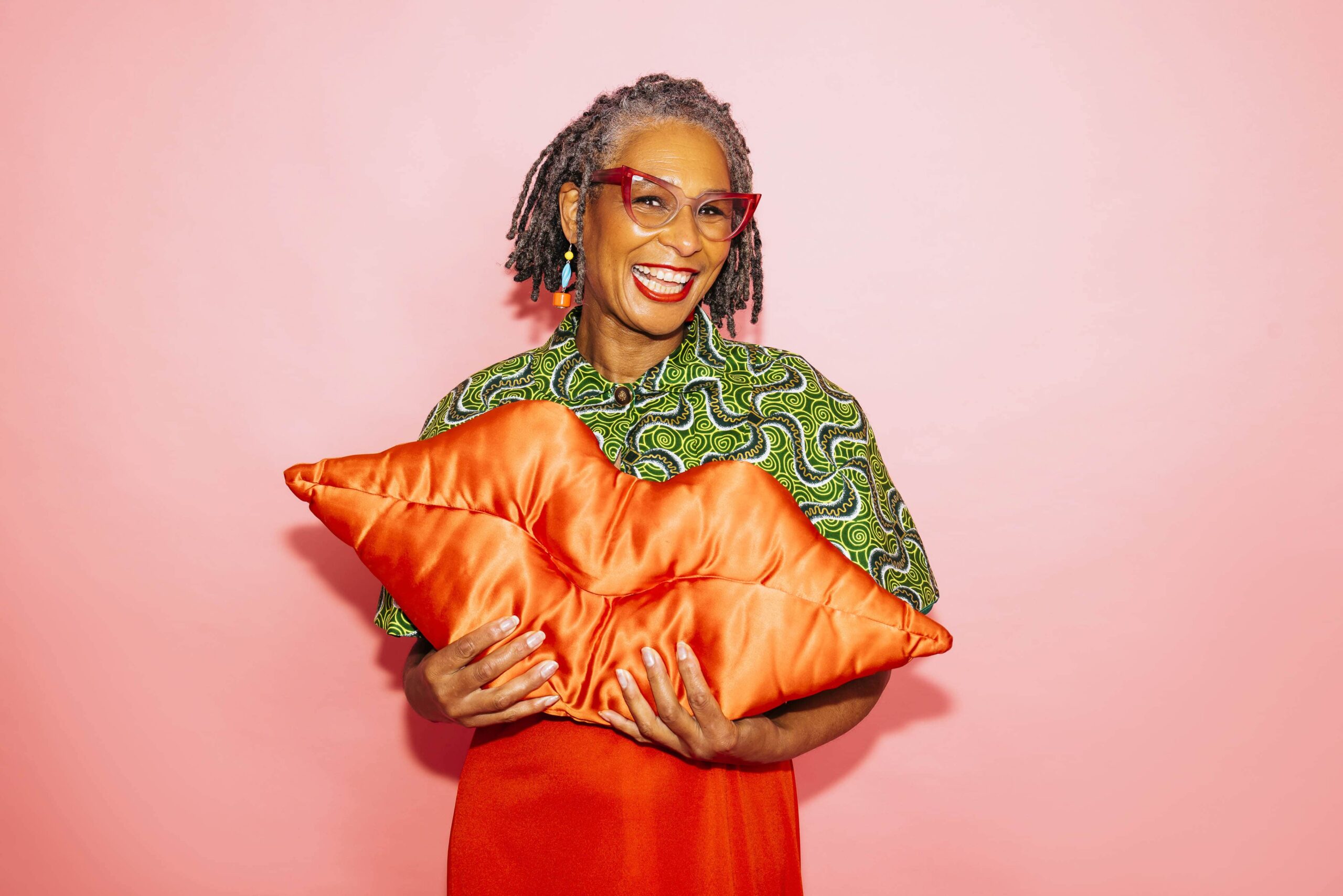 Karen Arthur holding a lips cushion