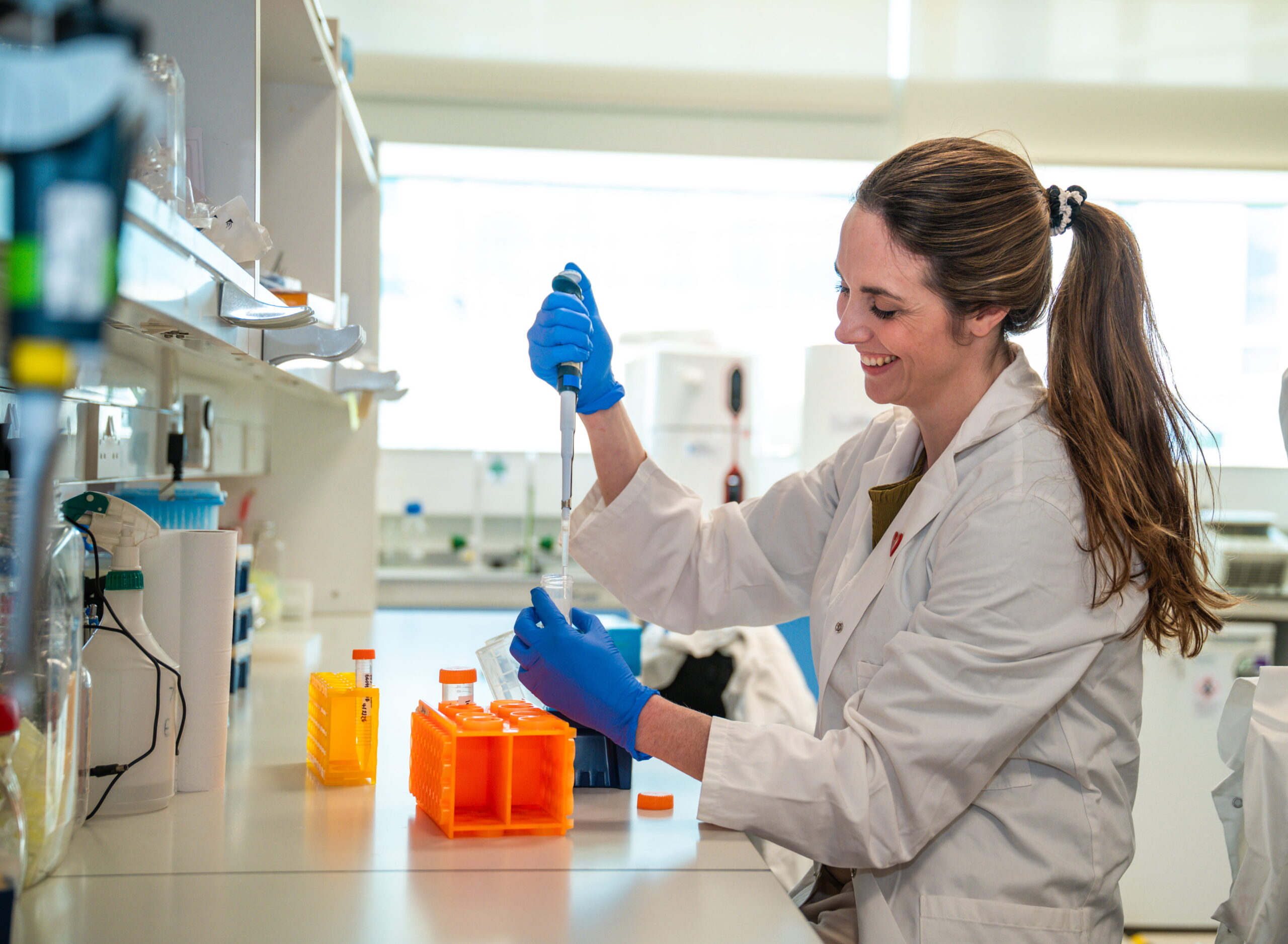 a photo of Dr Rachel Pounds pipetting in the lab